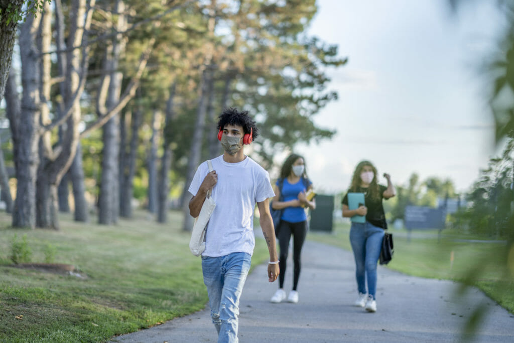 Students walking on school property while wearing masks