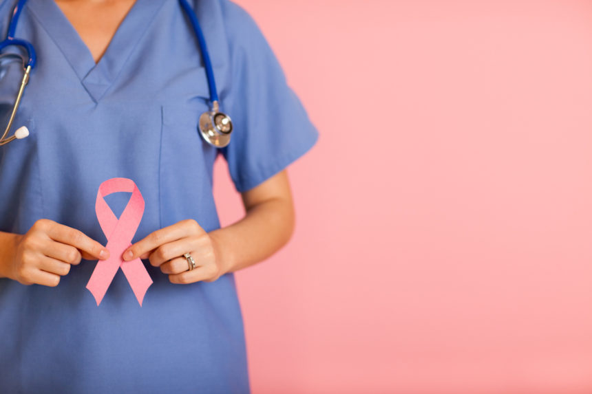 Female Nurse Holding Pink Breast Cancer Awareness Ribbon