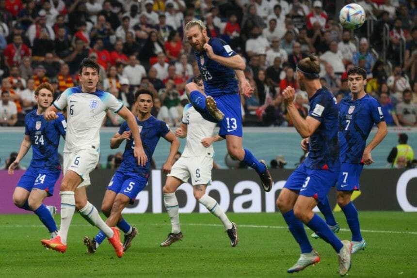 USA's defender #13 Tim Ream (top) kicks the ball during the Qatar 2022 World Cup Group B football match between England and USA at the Al-Bayt Stadium in Al Khor, north of Doha on November 25, 2022. (Photo by Paul ELLIS / AFP) (Photo by PAUL ELLIS/AFP via Getty Images)