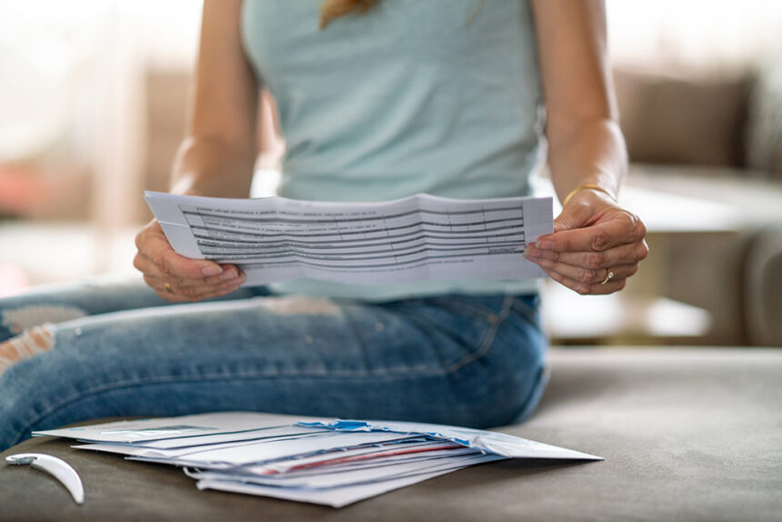 Close-up of woman looking at received mail at home