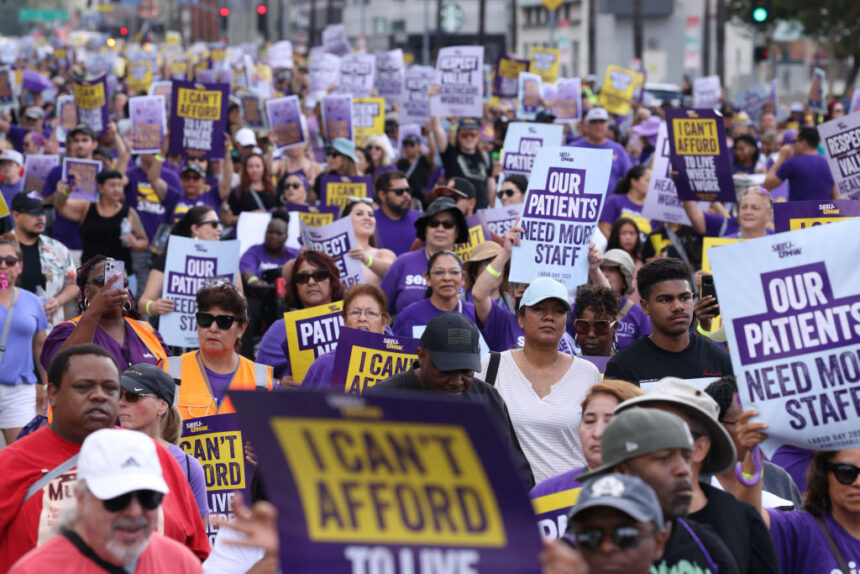 Health care workers march near Kaiser Permanente's Los Angeles Medical Center on Sept. 4