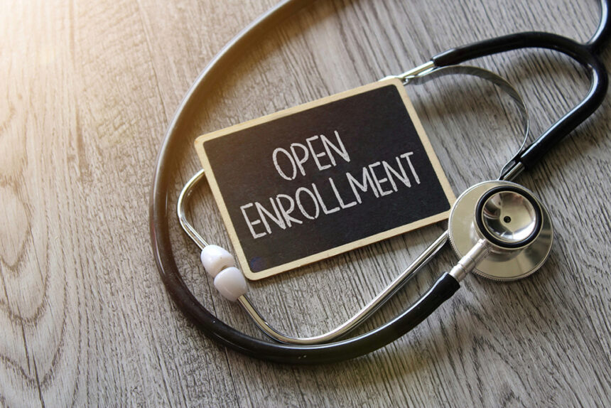 Stethoscope and chalkboard with text OPEN ENROLLMENT
