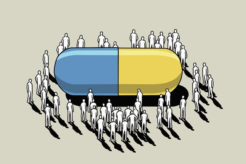Crowd surrounding large pharmaceutical capsule