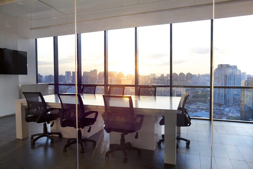 Meeting room with glass wall cityscape and sunset