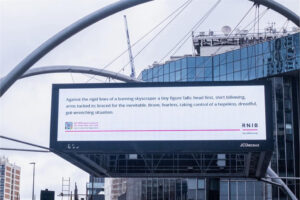 A billboard for the RNIB that stresses the importance of alt text for people with sight loss. It uses copy to describe a famous image, in this instance someone falling from a burning skyscraper