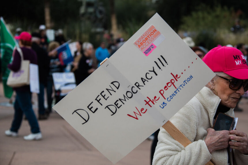 A protester carries a sign during a Women's March rally in Phoenix on Jan. 20.