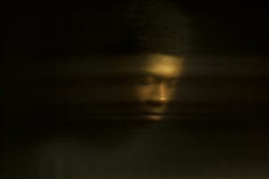Distorted portrait of dark skinned male,reflection